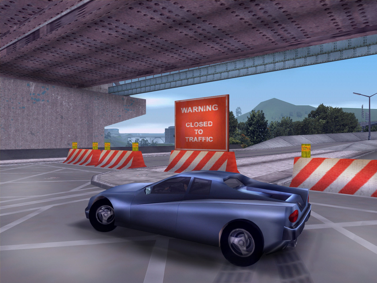 A blue sports car beneath a bridge in Liberty City in GTA III
